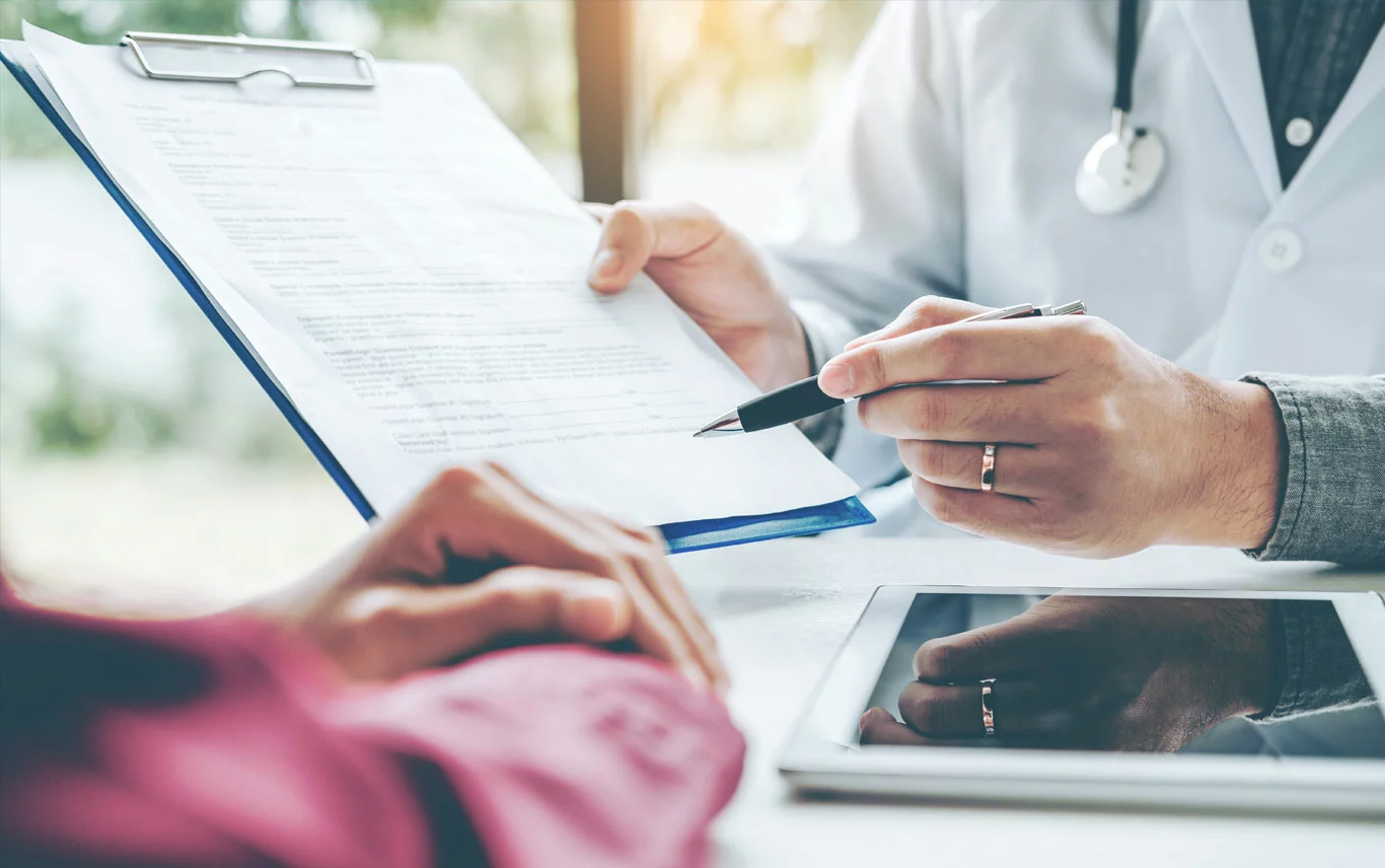 Pharmacist helping patient fill out a form