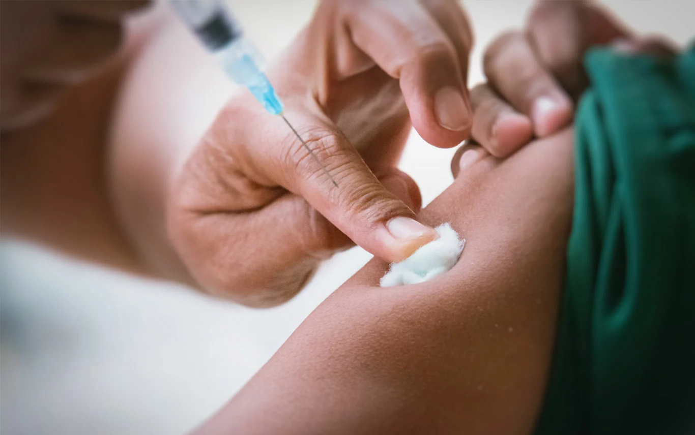 Pharmacist giving patient a vaccine