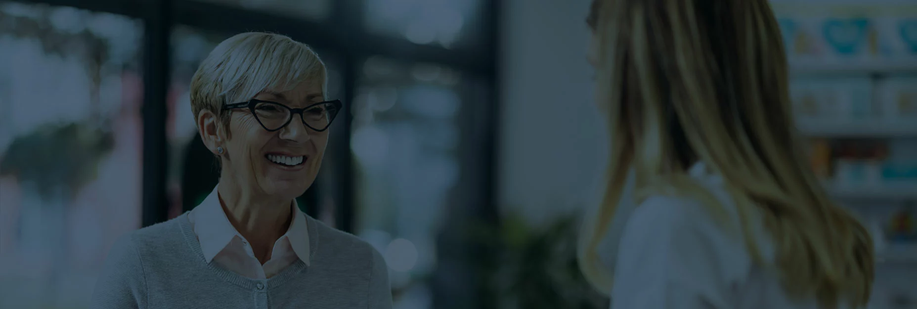 smiling woman during consultation with pharmacist 